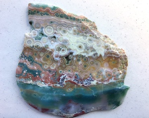 Hyper-heterogeneous slab from Vein 1/2 with ultra-rare vivid translucent blues, ~6.5in wide, Front. Cut by Owyhee Gemstones, Idaho.