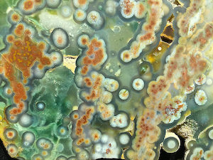 Broad relief, translucent spherulites in a translucent chalcedony matrix