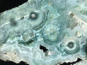 Figure 5 (Right): Specimens showing large spherulites of coarsely crystalline quartz and a very small nucleus. The interspersed outline forms with irregular geometries are cross-sections of such coarse quartz crystals. Similar to Lieber's Fig. 5 (Right). This specimen shown here is also from an early collection (ORCA), and is a somewhat rare variety. Picture length: ~45mm.